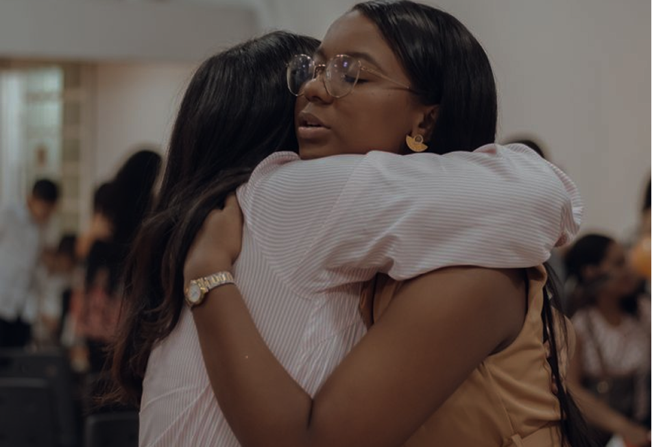 Two people embracing at a Gathr community event